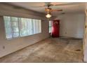 A bright living room features large windows, allowing ample natural light to illuminate the space at 5630 47Th N Ave, Kenneth City, FL 33709