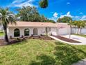 Attractive single-story home boasting tasteful landscaping and a welcoming curb appeal at 603 Ivey Ln, Tarpon Springs, FL 34689