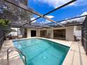 Inviting screened-in pool area with ample space for relaxation and entertainment at 603 Ivey Ln, Tarpon Springs, FL 34689