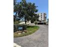 Exterior of a condo building featuring lush landscaping and a clearly marked address at 6218 Palma Del Mar # 303, St Petersburg, FL 33715