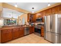 Well-equipped kitchen featuring stainless steel appliances, granite countertops, and wood cabinetry at 6677 84Th N Ave, Pinellas Park, FL 33781