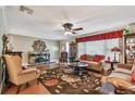 Comfortable living room with hardwood floors, ceiling fan, and classic decor at 9548 141St St, Seminole, FL 33776