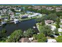 A waterfront home with a private dock, a pool, and mature trees along the waterway at 10729 Drummond Rd, Tampa, FL 33615