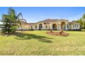 Sprawling single-story home featuring a manicured front lawn and elegant architectural details with pillars at 1109 Colson Rd, Plant City, FL 33567