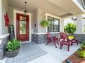 Inviting front porch with a cozy seating area and decorative elements adding charm at 11219 Paddock Manor Ave, Riverview, FL 33569