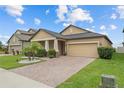 Charming single Gathering home with a two-car garage, beautiful landscaping, and a brick driveway at 11308 Chilly Water Ct, Riverview, FL 33569