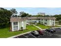Well-maintained condo building featuring a lush lawn, parking and a nice entrance at 1250 S Pinellas Ave # 207, Tarpon Springs, FL 34689
