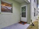 Charming condo front door with decorative wreath, 'Welcome Home' mat, and a cozy entrance at 1250 S Pinellas Ave # 207, Tarpon Springs, FL 34689