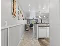 Charming hallway with tiled floors leading into a living area and showcasing coastal decorations at 12760 Indian Rocks Rd # 1049, Largo, FL 33774
