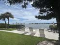 Waterfront seating area with lounge chairs and serene water views at 12760 Indian Rocks Rd # 904, Largo, FL 33774
