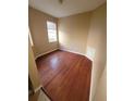 This bedroom features beautiful hardwood floors and neutral-colored walls at 19239 Stone Hedge Dr, Tampa, FL 33647