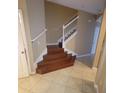 A beautiful staircase features wood steps, white risers, and white railings at 19239 Stone Hedge Dr, Tampa, FL 33647