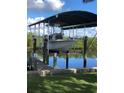Private boat dock featuring a covered lift, perfect for waterfront enjoyment at 2306 41St E St, Bradenton, FL 34208