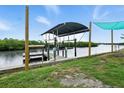 Waterfront property featuring a private boat dock with canopy, providing direct access to the open water at 2306 41St E St, Bradenton, FL 34208