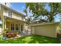 Outdoor area with a well-manicured lawn and detached garage at 2506 S Obrapia St, Tampa, FL 33629