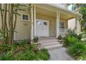 Close-up of the front porch featuring a double-door entry, decorative plants, and ample space at 2506 S Obrapia St, Tampa, FL 33629