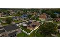 Aerial view of a single-Gathering home featuring solar panels and a fenced yard in a residential community at 25946 Buckthorn Ave, Land O Lakes, FL 34639