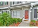 Close-up of a home's entry with a charming front door, and lush landscaping at 267 Countryside Key Blvd, Oldsmar, FL 34677
