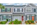 Charming townhome featuring a well-maintained exterior, landscaped yard, and inviting front entrance at 267 Countryside Key Blvd, Oldsmar, FL 34677