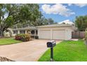 This single-story home boasts a two-car garage, well-kept lawn, and a mailbox at 3108 S Omar Ave, Tampa, FL 33629