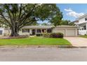 Inviting single-story home with a manicured lawn and convenient two-car garage at 3108 S Omar Ave, Tampa, FL 33629