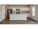 Contemporary kitchen with a large island, stainless steel appliances, and sleek white cabinetry at 36933 Sagemoor Dr, Zephyrhills, FL 33541