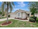 Charming single-story home featuring well-manicured landscaping and a two-car garage at 4129 Marlow Loop, Land O Lakes, FL 34639