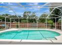 Refreshing screened-in pool offers a private outdoor retreat, perfect for relaxation at 4129 Marlow Loop, Land O Lakes, FL 34639