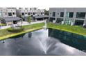 Aerial view showcasing the community with a serene pond, fountain and well-maintained landscaping at 4148 Gauge Line Loop, Tampa, FL 33624