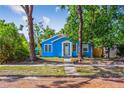 Charming blue bungalow with brick street and mature trees creating a picturesque setting at 4411 3Rd S Ave, St Petersburg, FL 33711
