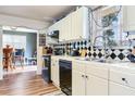 Bright kitchen with white cabinets, diamond-patterned backsplash, and stainless steel appliances at 5206 Cindy Kay Dr, Plant City, FL 33566