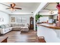 Inviting living room featuring an L shaped couch, wood floors, and an open layout at 5206 Cindy Kay Dr, Plant City, FL 33566