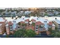 Beautiful condominium complex with a terracotta roof, lush landscaping, and serene waterfront views, close to shops and the beach at 610 Pinellas Bayway S # 5202, Tierra Verde, FL 33715