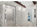 Entry hallway with stone wall and tile floors at 709 Pinewood Dr, Dunedin, FL 34698
