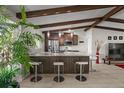 Modern kitchen with stainless steel appliances, granite countertops, and seating at the island at 709 Pinewood Dr, Dunedin, FL 34698