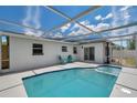 Relaxing screened-in pool with an attached spa and sunny skies overhead at 8045 Colton Dr, Port Richey, FL 34668