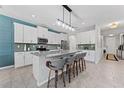 Modern kitchen with white cabinets, a large island with counter seating, and stainless steel appliances at 8050 Praise Dr, Tampa, FL 33625