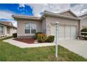Attractive one-story home with a tiled roof, lamp post and manicured landscaping at 8354 Palmetto Ct, Englewood, FL 34224