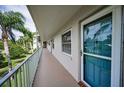 Hallway view with a teal front door at 960 Virginia St # 204, Dunedin, FL 34698