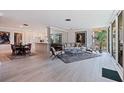 Bright open-concept living room featuring an attached dining area and access to the balcony at 1060 N Shore Ne Dr # 6, St Petersburg, FL 33701