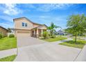 Beautiful exterior of a two-story home with a brick driveway, lush lawn, and mature landscaping at 11464 Chilly Water Ct, Riverview, FL 33569