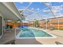 Screened-in pool area with ample seating, perfect for outdoor relaxation and entertainment at 12413 Dawn Vista Dr, Riverview, FL 33578
