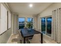 Bright dining room with ample natural light, stylish curtains, and sliding glass doors to the backyard at 13044 Wellspring Dr, Lithia, FL 33547