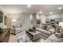 Open-concept living room with modern furnishings and an inviting atmosphere, seamlessly connected to the kitchen at 13044 Wellspring Dr, Lithia, FL 33547