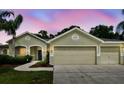 Inviting front exterior showcasing lush landscaping, a well-maintained lawn and a charming architectural design at 15217 Octavia Ln, Odessa, FL 33556