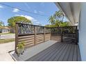 Cozy front porch featuring a modern privacy screen and composite deck at 2 79Th S St, St Petersburg, FL 33707
