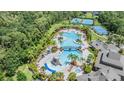 Stunning aerial view of the community pool, tennis courts and lush greenery at 20302 Noble Oak Pl, Tampa, FL 33647