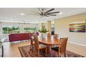 Cozy dining room featuring an area rug, a ceiling fan, and expansive views of the outdoors at 2110 W View Dr, Sun City Center, FL 33573