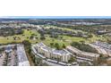 Scenic aerial view of a condo building overlooking a well-maintained golf course with water features and mature trees at 225 Country Club Dr # 1506, Largo, FL 33771