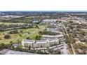 High-angle shot showcasing a multi-story condo building with views of the adjacent golf course and surrounding neighborhood at 225 Country Club Dr # 1506, Largo, FL 33771